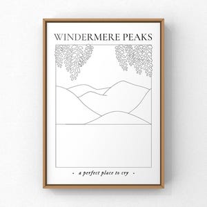 May include: Framed art print with a minimalist black and white illustration. The artwork features mountain silhouettes, hanging foliage, and the text "WINDERMERE PEAKS" and "a perfect place to cry."