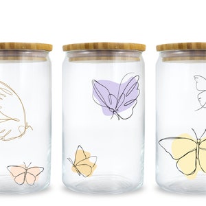 May include: Set of three glass jars with bamboo lids. Each jar features a different butterfly design with a line art style. The butterflies are in shades of yellow, purple, and pink.