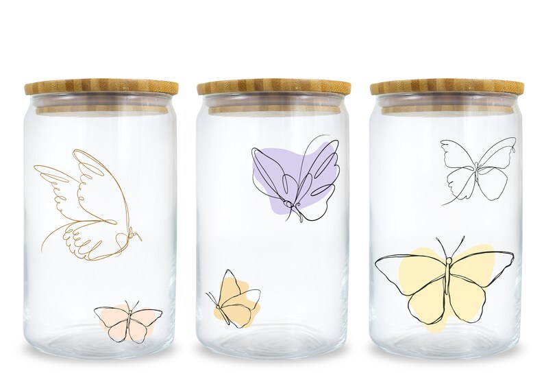 May include: Set of three glass jars with bamboo lids. Each jar features a different butterfly design with a line art style. The butterflies are in shades of yellow, purple, and pink.