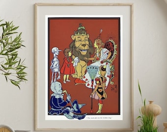 May include: A vintage illustration of the Wizard of Oz characters. Dorothy, the Scarecrow, the Tin Man, the Cowardly Lion, and the Wicked Witch of the West are all present. The text at the bottom reads "You must give me the Golden Cap."