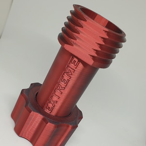 May include: A red metal pipe with a threaded end and a knurled cap. The pipe is labeled "EXTREME".