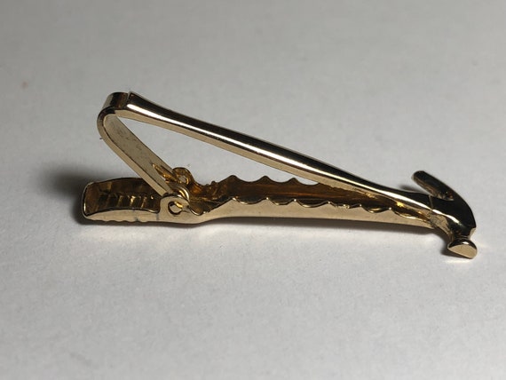 some sort of tiny brass hammer with an alligator clip? : r