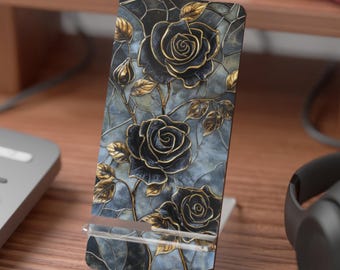 May include: A phone case with a design of black roses with gold accents on a blue background.