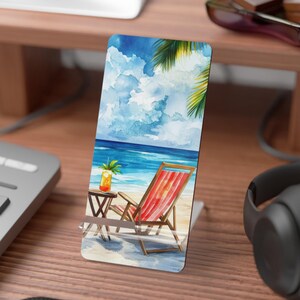 May include: A watercolor painting of a beach scene with a red and white beach chair, a small table with a tropical drink, and a palm tree in the background.