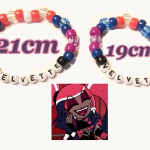 May include: Two beaded bracelets, one 21cm and the other 19cm in circumference, feature a mix of colorful beads. The word "VELVETTE" is spelled out on each bracelet. An image of a cartoon character is in the lower corner.