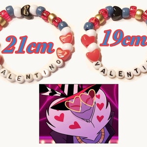 May include: Two beaded bracelets, one 21cm and the other 19cm in length, with the name "VALENTINO" spelled out. The bracelets feature red, white, gold, and blue beads, including heart-shaped beads. A cartoon image is in the lower part of the image.
