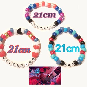 May include: Three colourful beaded bracelets, each 21 cm in circumference, with names spelled out in white letter beads. One bracelet features red heart beads. The image includes a cartoon graphic.