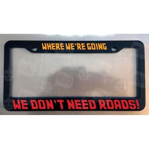 Where We&#39;re Going We Don&#39;t Need Roads Glossy Black License Plate Frame
