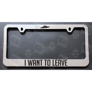 May include: A silver metal license plate frame with a black UFO silhouette and the text "I WANT TO LEAVE".
