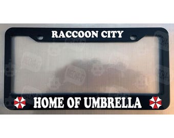 Marco para matrícula negro brillante de Raccoon City, sede de Umbrella