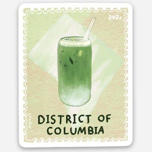 May include: A postage stamp illustration featuring a glass of iced matcha latte with a straw. The background is a pale green shade with a white diamond shape. The text reads 202¢, SALGU, and DISTRICT OF COLUMBIA in dark green lettering.