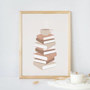 May include: A framed print of a stack of books with a cup of coffee on top. The books are in shades of brown and beige, and the coffee cup is white with brown speckles. The background is a light beige.