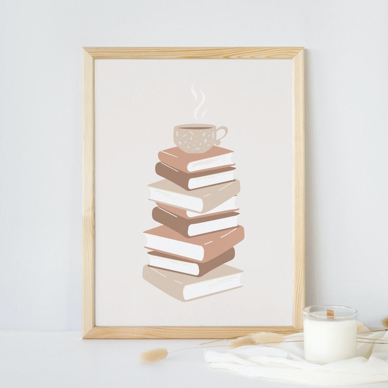 May include: A framed print of a stack of books with a cup of coffee on top. The books are in shades of brown and beige, and the coffee cup is white with brown speckles. The background is a light beige.