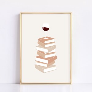 May include: A stack of books with a glass of red wine on top. The books are in shades of beige and brown.