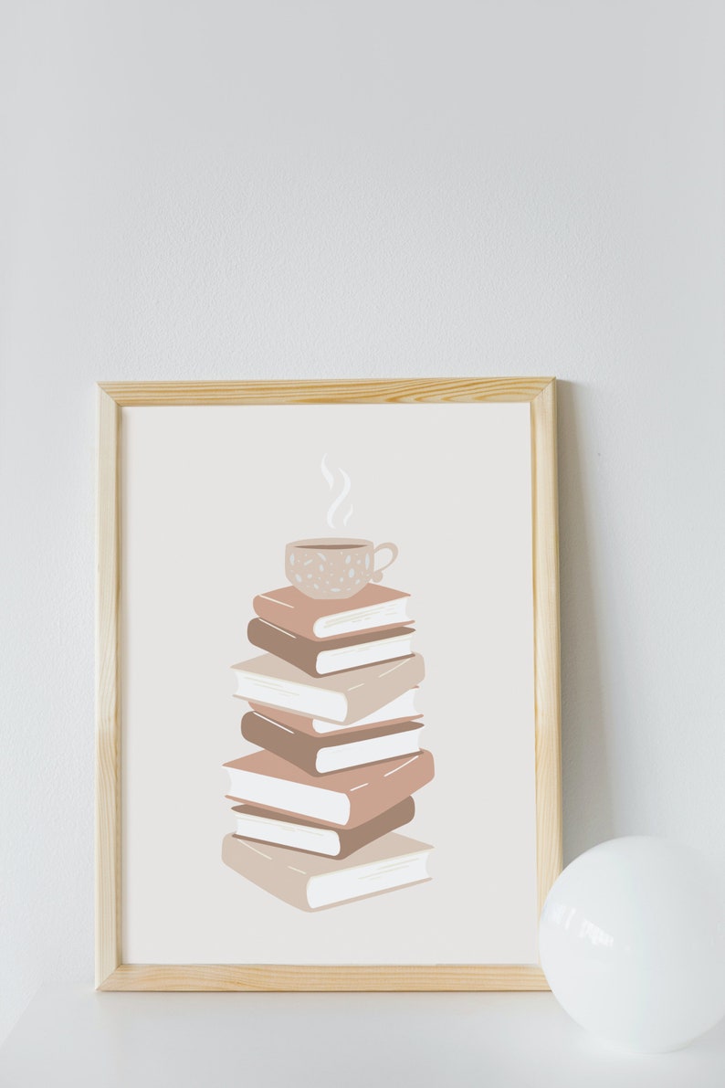 May include: A framed print of a stack of books with a cup of coffee on top. The books are in shades of brown and beige, and the coffee cup is white with brown speckles. The background is a light beige.