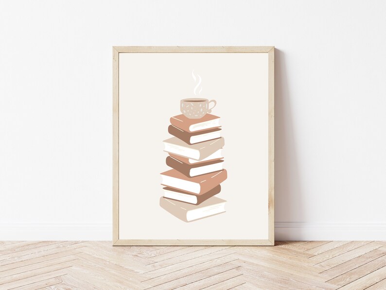May include: A framed print with a stack of books and a cup of coffee on top. The books are in shades of brown and beige, and the coffee cup is brown with white speckles. The background is a light beige.