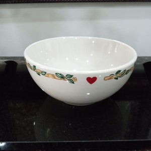 May include: White ceramic bowl with a green vine and red heart design.