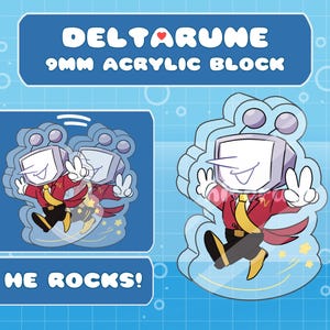 May include: A clear acrylic block with a cartoon character from Deltarune. The character, with a TV-shaped head, is shown in a red jacket, yellow tie, and black trousers, giving a peace sign. Text reads "DELTARUNE 9MM ACRYLIC BLOCK" and "HE ROCKS!"