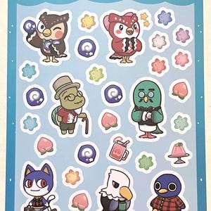 Peut inclure: Une planche d'autocollants avec des personnages d'Animal Crossing. Le fond est bleu clair avec les mots "animal crossing" et "part 2". Les autocollants incluent des hiboux, un chat, un pingouin et d'autres personnages, ainsi que des éléments décoratifs.