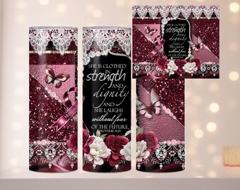 May include: A pink and burgundy tumbler with a white lace design and a quote that reads "She is clothed in strength and dignity and she laughs without fear of the future."  Proverbs 3:25. The tumbler features a butterfly and a pink ribbon.