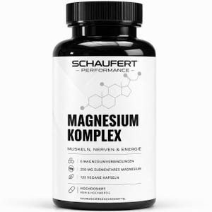 May include: A black bottle of Schaufert Magnesium Komplex supplements. The white label features black text, including "Magnesium Komplex", "Muscles, Nerves & Energy", and supplement facts. The bottle has a black cap.