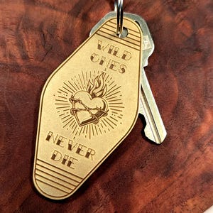 Wild Ones Never Die Keychain – Brass, Titanium, or Stainless Steel Key Fob – Sacred Heart Tag – Vintage Motel Style [70mm]