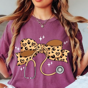 Comfort Colors® Coquette Nurse Stethoscope Bow Shirt, Gift for Nurse, Nurse Bow Shirt, Coquette Nurse Shirt, Leopard Nurse Ribbon Shirt