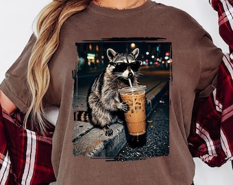 Comfort Colors® Raccoon Drinking Iced Coffee Shirt, Retro Prehistoric Shirt, Gift For Animal Lover, Funny Animal Meme Tee,Coffee Raccoon Tee