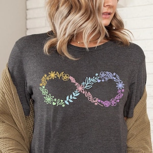 May include: A dark gray t-shirt with a rainbow floral infinity symbol design.