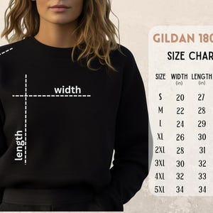 May include: A black sweatshirt with a size chart for Gildan 18000 apparel. The chart lists sizes S to 5XL, with measurements for width, length, and sleeve length in inches. The word "width", "length", and "sleeve" are labeled on the sweatshirt.