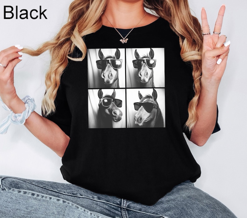 May include: Black t-shirt with a graphic of four horses wearing sunglasses. The horses are arranged in a grid pattern.