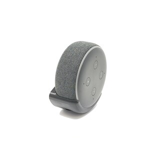 May include: A grey fabric-covered smart speaker with a black plastic base and control buttons. The speaker is mounted on a wall.