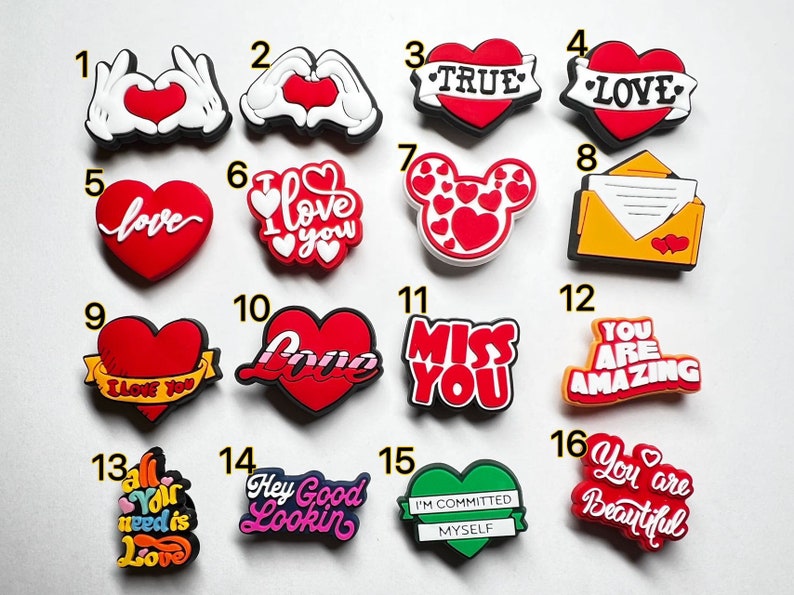 May include: A set of 16 colorful heart-shaped shoe charms with various love-themed messages, including "I love you", "True Love", "Miss You", and "You are Amazing".