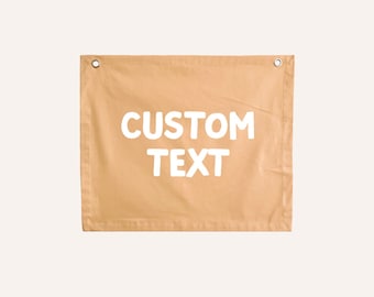May include: A tan canvas banner with the text "CUSTOM TEXT" printed in white.
