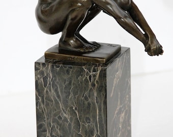 impressive bronze statue of a diver on a veined marble base
