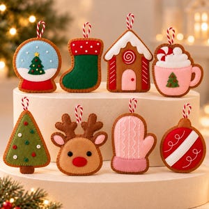 May include: A set of eight felt Christmas ornaments featuring a snow globe, stocking, gingerbread house, mug, tree, reindeer, mitten, and bauble. Each ornament has a red and white striped hanging loop and detailed stitching.
