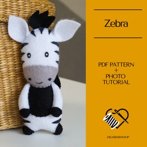 May include: A black and white felt zebra plush toy with a black mane and a smiling face. The toy is standing on a white surface. The image includes the text "Zebra", "PDF PATTERN + PHOTO TUTORIAL", and "HELISBABYSHOP".