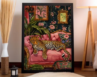 May include: A leopard lounges on a pink velvet chaise lounge with floral patterned cushions. The chaise is in a room with lush green plants and gold framed artwork.