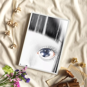 May include: A framed art print featuring a detailed illustration of an eye. The eye has long eyelashes and a reflective, galaxy-like iris. The artwork is primarily black and white, with a focus on the eye's intricate details and the surrounding hair.