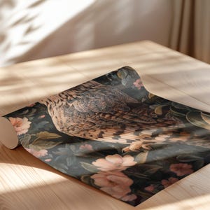 May include: A dark green and brown patterned wrapping paper features a detailed illustration of an owl with pink flowers and leaves.