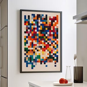 May include: A framed abstract art print with a colorful pixelated design in shades of red, orange, yellow, green, blue, and black.
