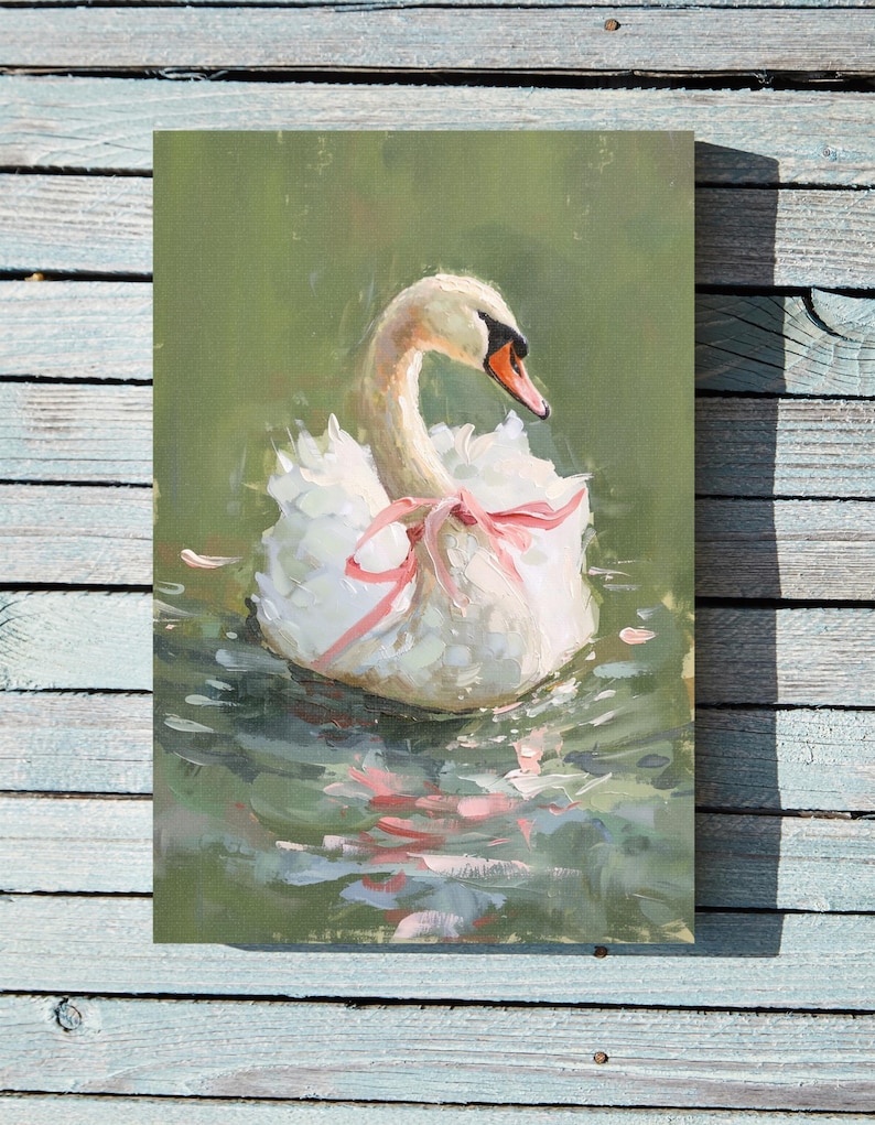 May include: A white swan with a pink ribbon around its neck floats in a pond with green water. The swan's reflection is visible in the water.