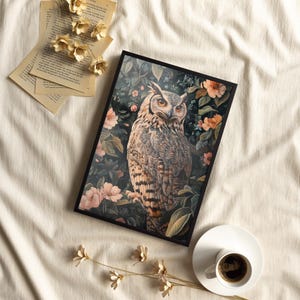 May include: A framed print of a detailed illustration of an owl perched in a lush garden setting. The owl is brown and gray with yellow eyes and is surrounded by green leaves and pink flowers.