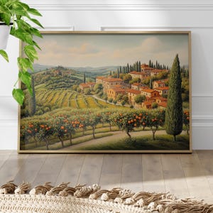 May include: A painting of a picturesque Italian countryside scene with rolling hills, vineyards, and a charming village nestled among the trees. The village features terracotta-colored buildings with red tile roofs, surrounded by lush greenery and orange trees.