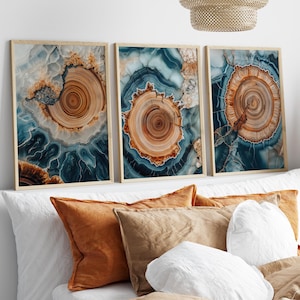 May include: Three abstract art prints with a blue, brown, and white agate pattern. The prints are framed in a light wood frame.
