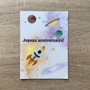 Karte zum Geburtstag in Frankreich. Fusée dans l'espace. Die Planeten, Galaxien. Geburtstagskarte im französischen Space. Rakete. Galaxie.