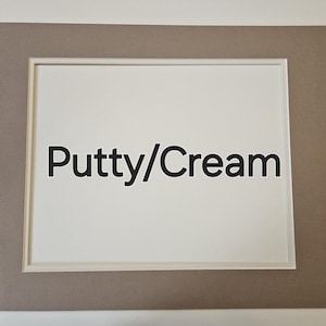 May include: A light brown picture frame with a white mount and the text "Putty/Cream" in black.