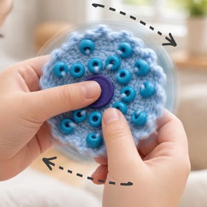 May include: A light blue crocheted fidget spinner featuring a dark purple center cap and multiple dark blue beads attached to the textured fabric surface. The object is shown in motion with dashed arrows indicating rotation.