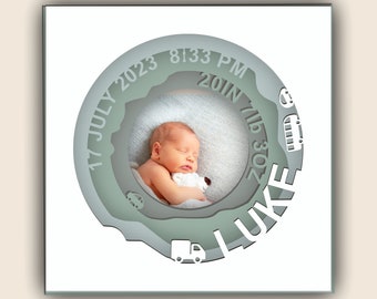 May include: A white frame with a green circle containing a baby's photo and the text "17 JULY 2023 8:33 PM 20 IN 7 LB 3 OZ LUKE".