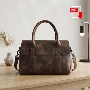May include: A dark brown leather handbag featuring two top handles, a rectangular main compartment with a flap closure, and two side attachment points for a shoulder strap. The bag has a distressed finish with visible tonal variations in the leather.
